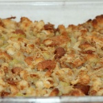 White baking dish with baked cornbread stuffing