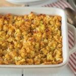 White baking dish with baked cornbread stuffing