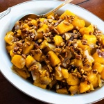 a bowl of roasted butternut squash with candied pecans and text roasted butternut squash with candied pecans