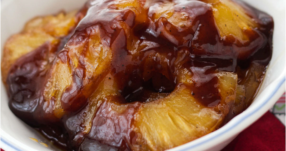 Caramelized pineapple rings in a white bowl.