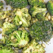 Overhead view of roasted broccoli with pine nuts