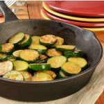 Sautéed zucchini in a cast iron skillet.