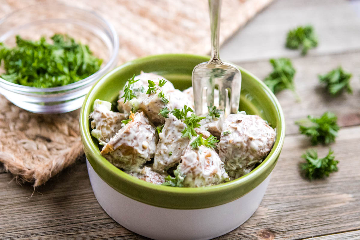 Bowl of potato salad with roasted potatoes.
