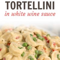 A white plate with tortellini, peas, and diced bell peppers covered in cream sauce. Text is Creamy Tortellini in White Wine Sauce - Add Salt & Serve logo