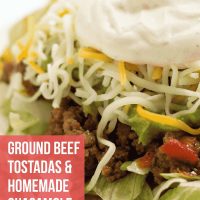 A plate with beef tostadas made with guacamole, shredded cheese, and sour cream. Text is Beef Tostados & Homemade Guacamole - Add Salt & Serve logo