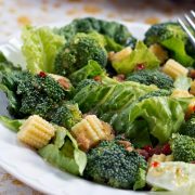 Baby Corn Salad with Broccoli on a plate with a fork.