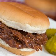 Barbecue Roast Beef Sandwich garnished with two pickle slices.