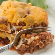 A slice of Layered Italian Beef Casserole being cut by a fork