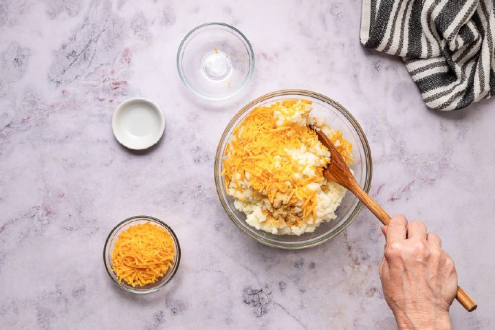 mixing cheese into mashed potatoes