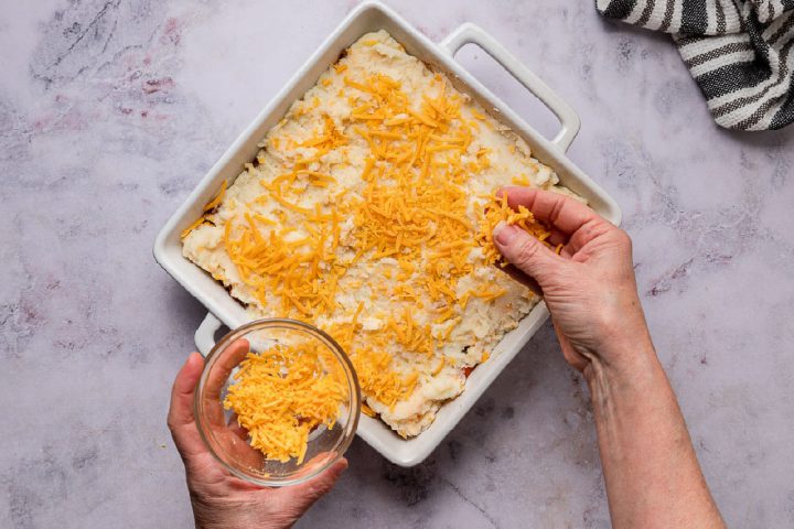 sprinkling cheese on top of shepherd's pie before baking
