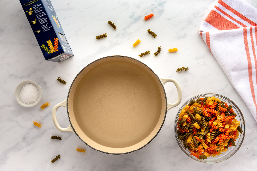 pan with water and a bowl of rotini