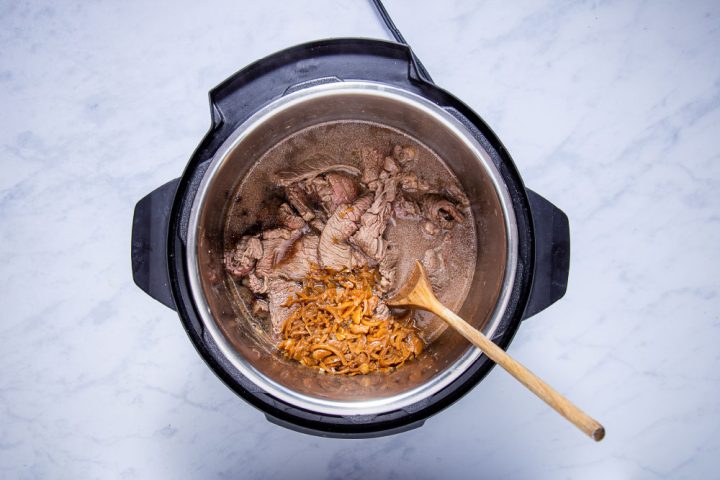 sliced sautéed chuck steak, french onion soup, and beef consomme in the instant pot