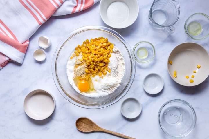 Bowl with ingredients for cornbread with corn kernels