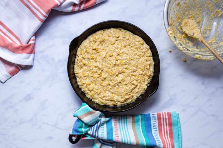 Cornbread batter in a cast iron skillet
