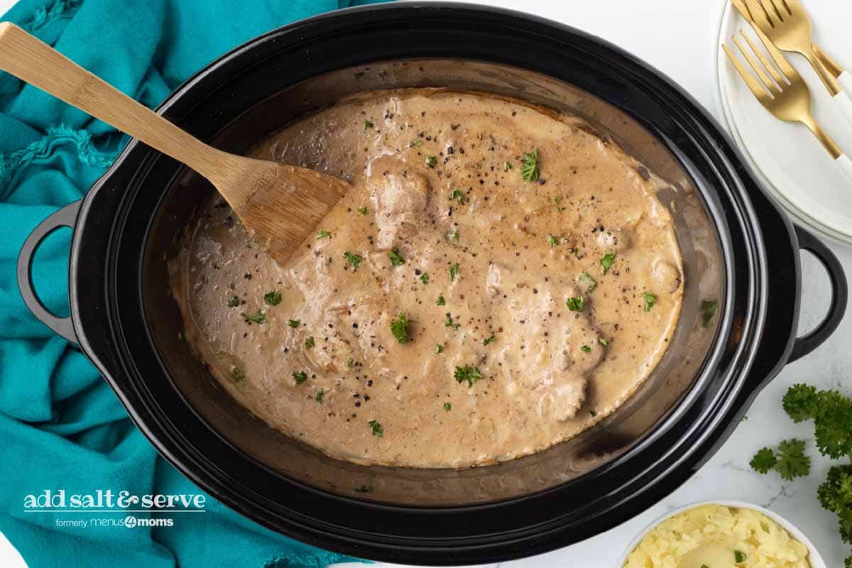 Cube steak with mushroom soup gravy after cooking in a crock pot.