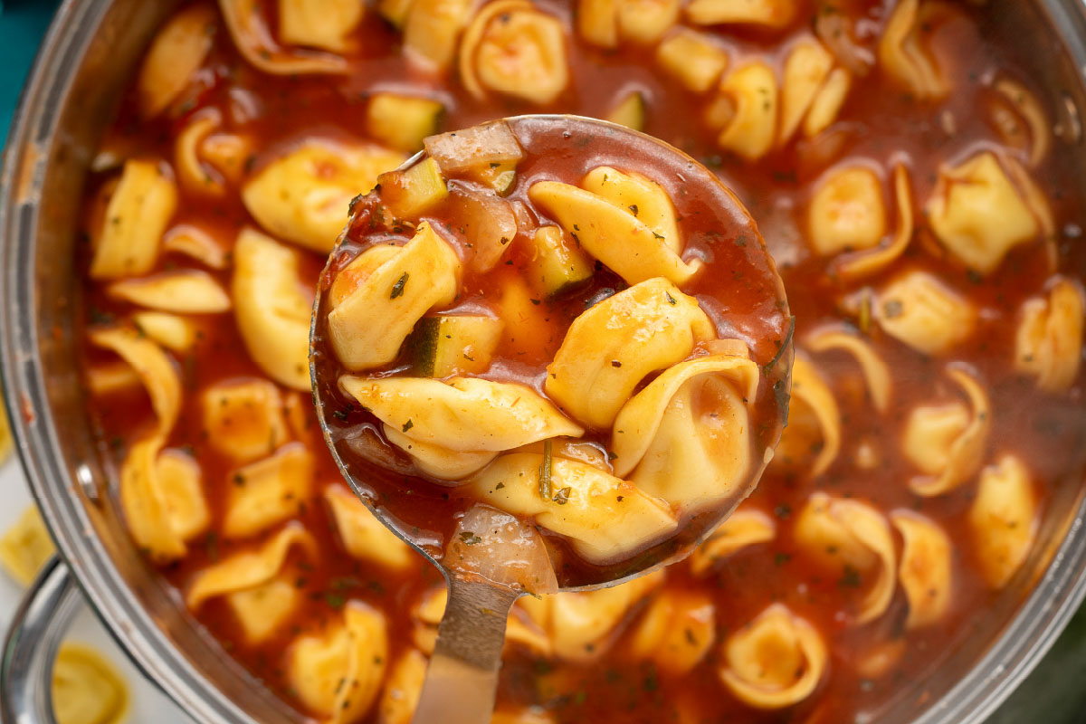 Tomato Zucchini Soup with tortellini in a pot.