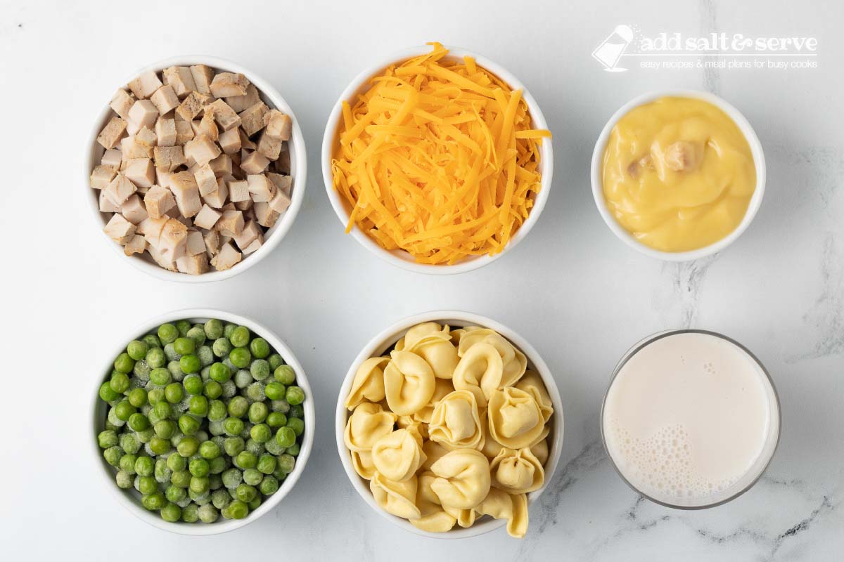 Ingredients for Leftover Turkey Tortellini Casserole: cream of chicken soup, cheese tortellini, frozen peas, shredded cheddar cheese, leftover turkey, and milk.