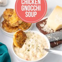 Bowl of copycat Olive Garden Chicken Gnocchi Soup with toasted garlic bread and a spoon in the bowl with the soup.