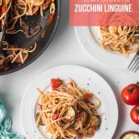 Easy stovetop zucchini linguine on a plate with skillet of same.