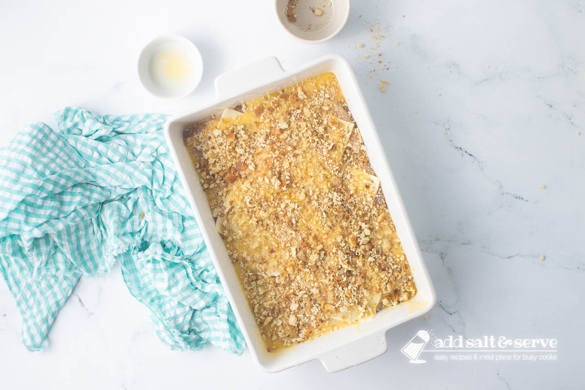 Casserole dish of Swiss chicken with white wine and stuffing before baking.