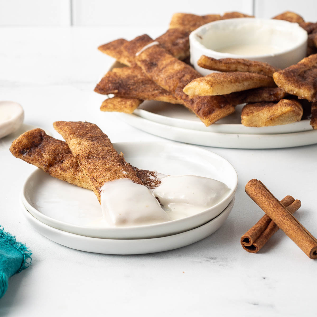 Baked cinnamon sticks encrusted with cinnamon sugar in butter and served with vanilla icing.