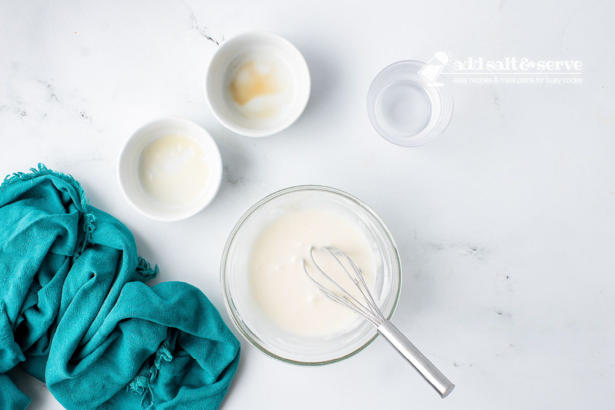 Vanilla icing for homemade cinnamon sticks made from milk, vanilla, and powdered sugar.
