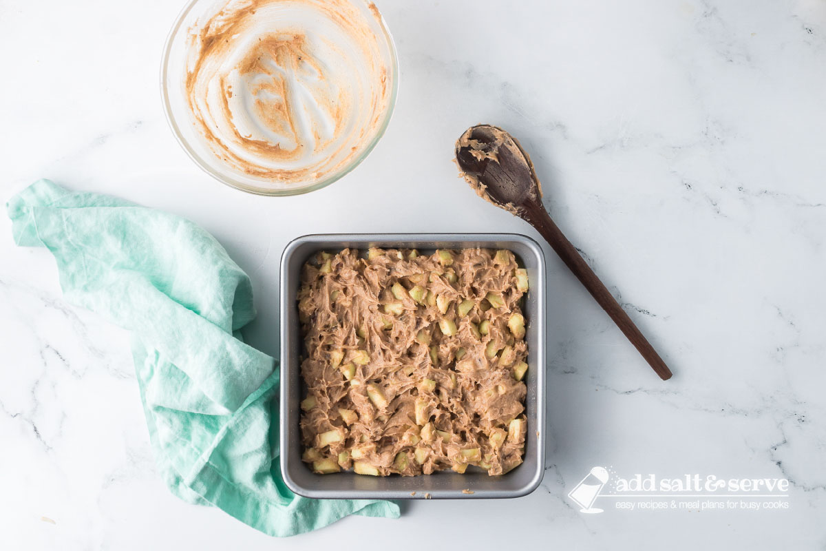 Apple Walnut Bar batter spread in a prepared 9-inch by 9-inch baking pan.