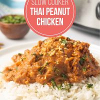 Plated slow cooker Thai Peanut Chicken over rice garnished with chopped peanuts and cilantro.