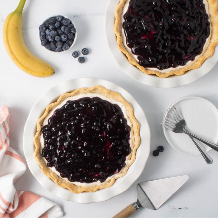 Overhead view of two Blueberry Banana Pies on a counter.