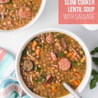 Two bowls of lentil soup with kielbasa, spinach, carrots, onion, and green pepper with a spoon in one bowl and text Slow Cooker Lentil Soup.