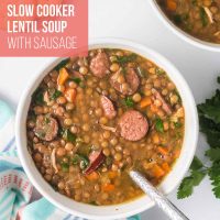 Bowl of lentil soup with kielbasa, spinach, carrots, onion, and green pepper with a spoon in the bowl and text Slow Cooker Lentil Soup with Sausage.