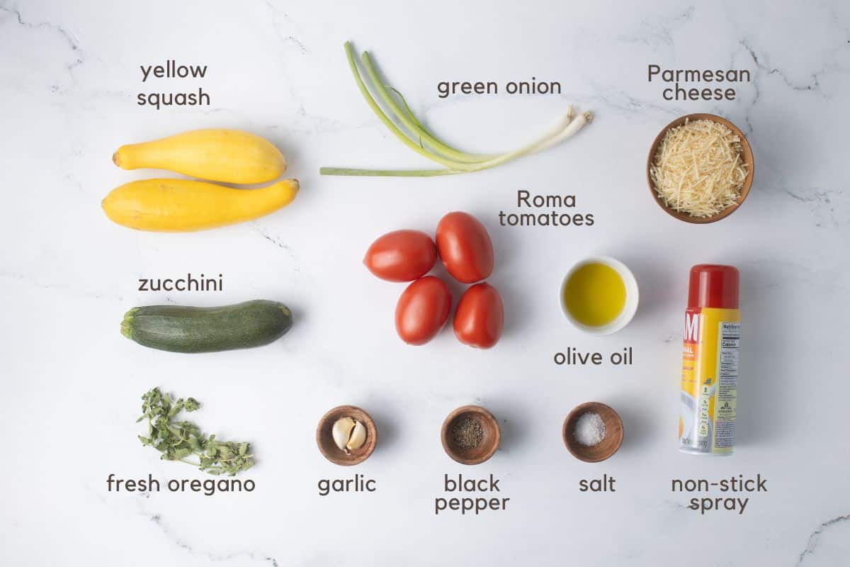 Ingredients for Tomato and Squash Casserole: yellow squash, zucchini, green onion, roma tomatoes, Parmesan cheese, olive oil, non-stick spray, fresh oregano, garlic, black pepper, and salt.