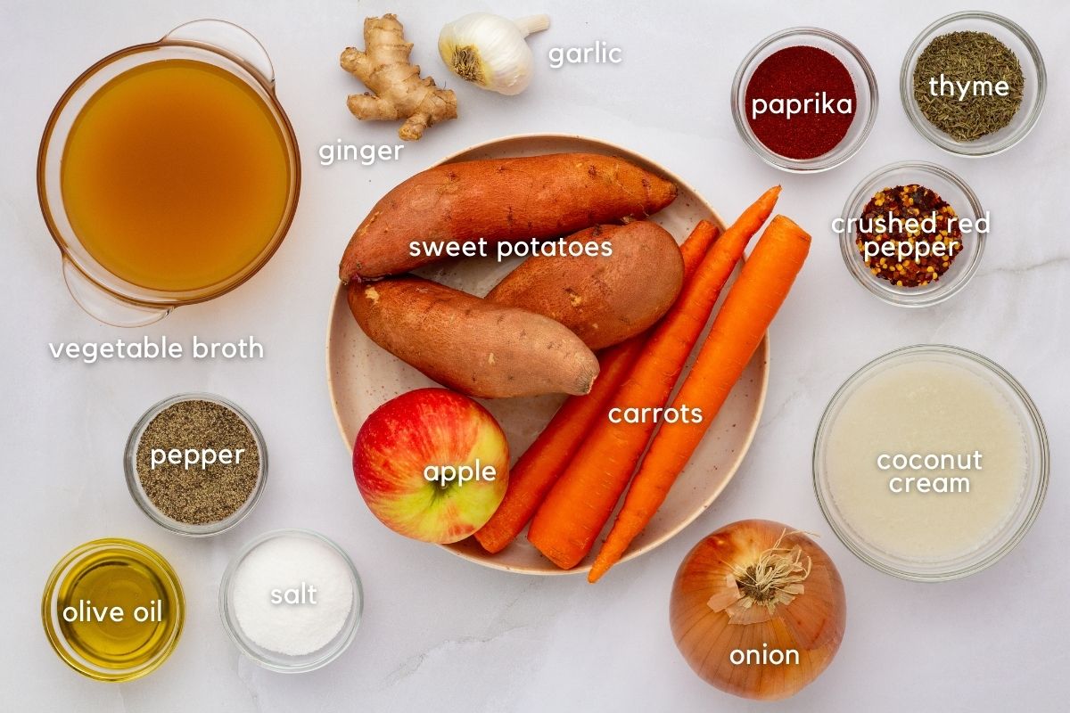 Ingredients for Carrot, Sweet Potato & Ginger Soup: vegetable broth, ginger, garlic, paprika, thyme, crushed red pepper, oil, salt, pepper, onion, coconut cream, apple, carrot, and sweet potato.