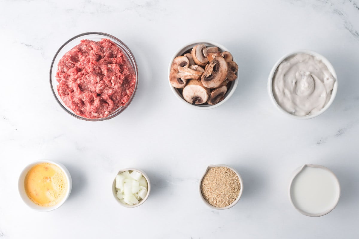 Ingredients for Salisbury Steak with Cream of Mushroom Soup: ground beef, fresh mushrooms, cream of mushroom soup, egg, onion, bread crumbs, milk.