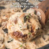 A Salisbury Steak patty in mushroom cream sauce in a black pan with a serving spoon and text Easy Mushroom Salisbury Steak with cream of mushroom soup.