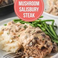 White plate with a Salisbury Steak patty and mashed potatoes smothered in mushroom cream sauce with green beans and text Easy Mushroom Salisbury Steak.