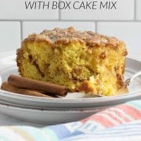 Slice of Honey Bun Cake on a plate showing the cinnamon swirl in the middle and vanilla glaze on top with a forkful of cake laying on the plate beside it with text Honey Bun Cake with box cake mix.
