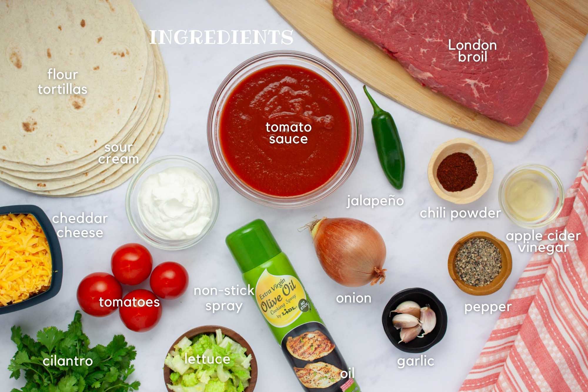 Ingredients for beef burritos: flour tortillas, tomato sauce, jalapeño, cheddar cheese, sour cream, tomatoes, cilantro, lettuce, onion, garlic, pepper, chili powder, apple cider vinegar, London Broil, and non-stick spray.