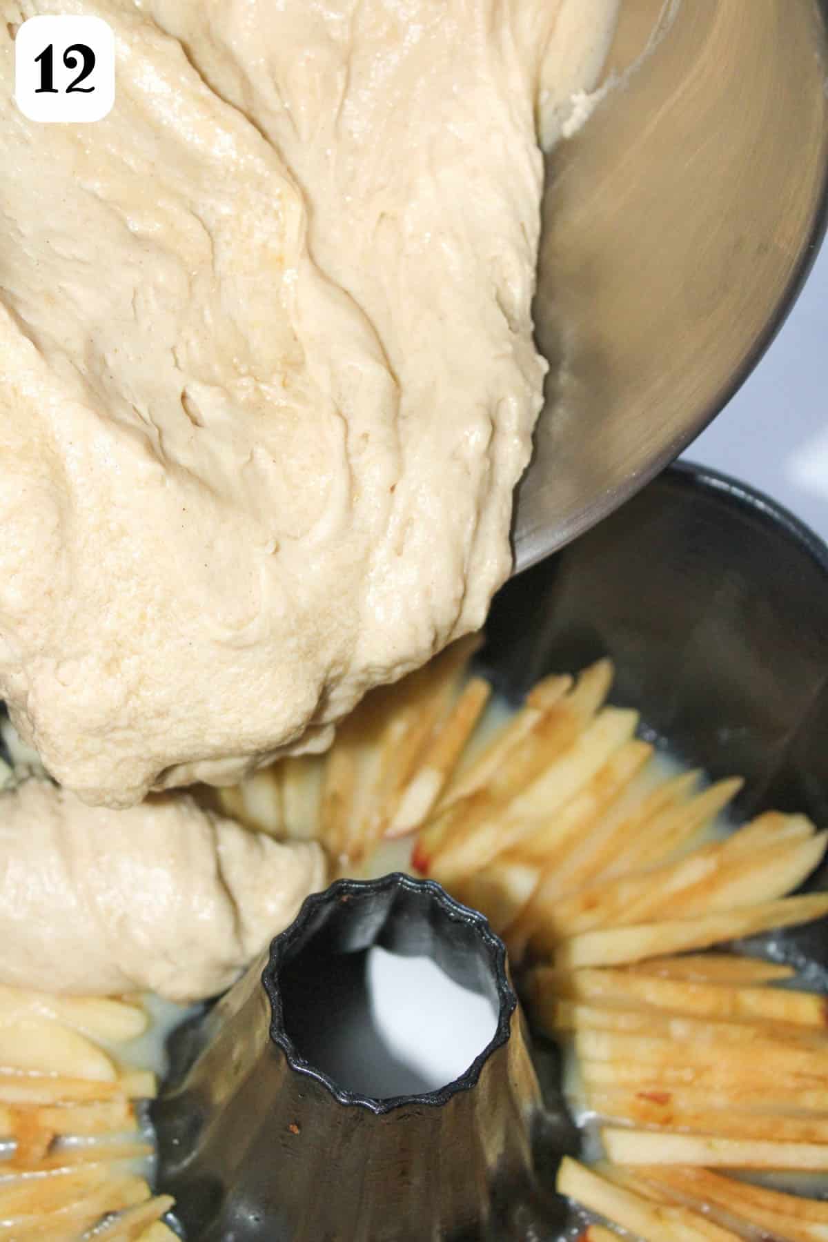 12- Adding cake batter over sliced apples in a bundt pan.