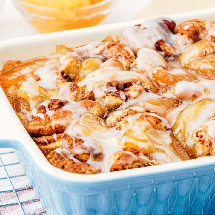 Apple cinnamon roll bake in pan with glaze on top.