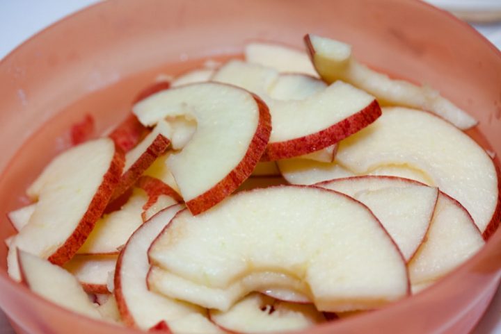 Bowl of sliced apples and text Add Salt & Serve
